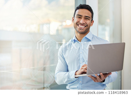 Businessman, smile portrait and laptop at office window with internet connection and career pride. Happy asian male entrepreneur with technology, internet and space for networking, email and work 118418963