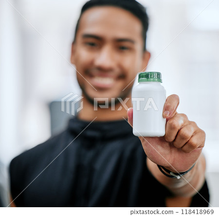 Fitness drugs, hand and a man at the gym with a supplement for training and sport. Happy, portrait and an Asian athlete showing a bottle of medicine or vitamins for sports wellness and exercise Fitness drugs, hand and a man at the gym with a supplement for training and sport. Happy, portrait and an Asian athlete showing a bottle of medicine or vitamins for sports wellness and exercise 118418969
