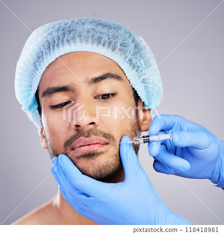 Hands, face and plastic surgery with a man in studio on a gray background for injection. Needle, beauty and transformation with a male customer in a clinic for antiaging filler or cosmetics Hands, face and plastic surgery with a man in studio on a gray background for injection. Needle, beauty and transformation with a male customer in a clinic for antiaging filler or cosmetics 118418981