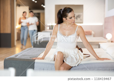 Adult woman chooses mattress in store 118419467