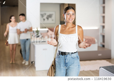 Young girl watching large stock of goods in furniture shop Young girl watching large stock of goods in furniture shop 118419630