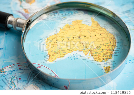 Bangkok, Thailand - June 15, 2024 East Australia, Magnifying glass close up with colorful world map, travel, geography, tourism and exploration. 118419835