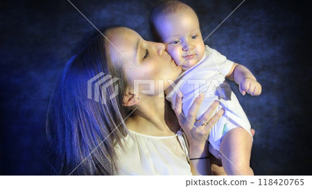 Mother kissing her child on the cheek 118420765