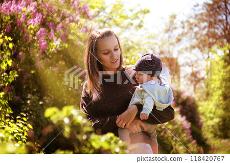 A mother holds her son in her arms. A mother holds her son in her arms. 118420767