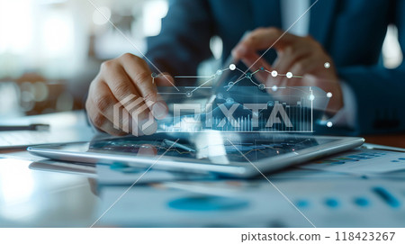A man is using a tablet to draw graphs and charts 118423267