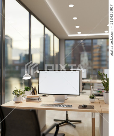 A computer desk by the window with a stunning view of city skyscrapers. A computer desk by the window with a stunning view of city skyscrapers. 118423907