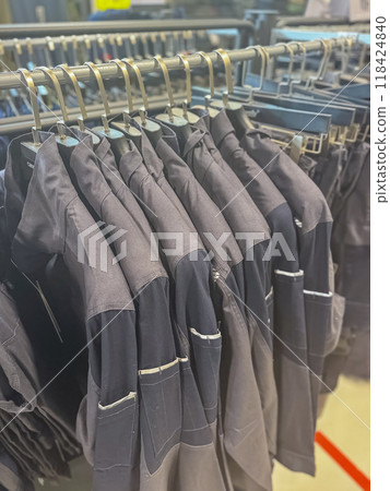 special workers jackets hanging in shop . High quality photo 118424840