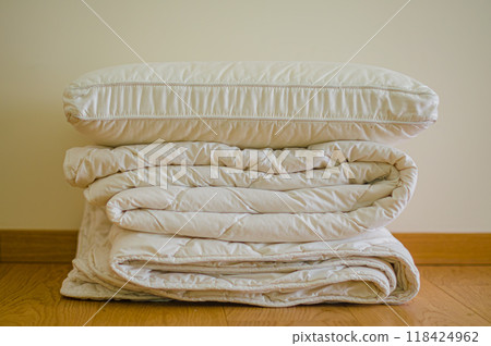 Soft stack folded blanket and pillows on the wooded floor in room . High quality photo Soft stack folded blanket and pillows on the wooded floor in room . High quality photo 118424962