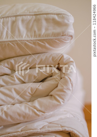 side view of Stack of beddings , white pillow on the duvet . High quality photo side view of Stack of beddings , white pillow on the duvet . High quality photo 118424966