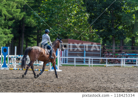 A girl practicing horse riding 118425334