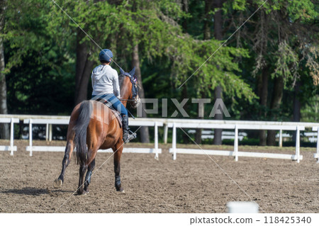 A girl practicing horse riding 118425340