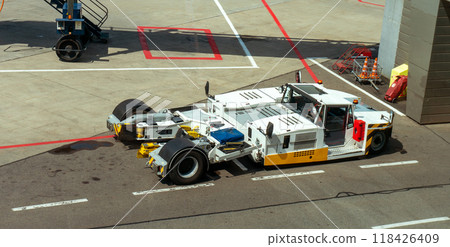 A towbarless tractor on the airfield. Preparing airliners for flight. Auxiliary vehicles. A towbarless tractor on the airfield. Preparing airliners for flight. Auxiliary vehicles. 118426409