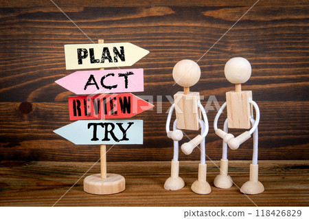 Improvement concept. Miniature road sign arrows on wood texture background 118426829