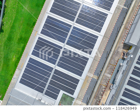 Solar energy for factory and warehouse building. Solar panels on roof of industrial plant. Commercial solar power. Rooftop solar power. Rooftop renewable energy system. Sustainable green energy. 118426949