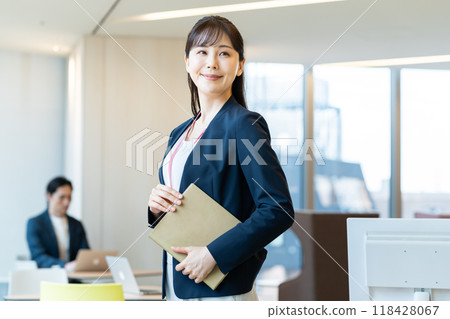 Businesswomen working in an office. Photo courtesy of Denpa Gakuen, Tokyo Electronics College. Businesswomen working in an office. Photo courtesy of Denpa Gakuen, Tokyo Electronics College. 118428067