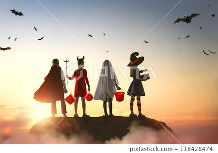 children in carnival costumes at Halloween children in carnival costumes at Halloween 118428474