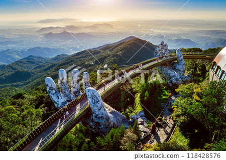 Tourist walking at Golden bridge in Bana hills, Da nang, Vietnam. Tourist walking at Golden bridge in Bana hills, Da nang, Vietnam. 118428576