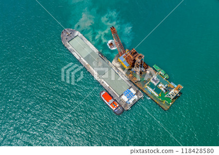 Sand dredger on floating platforms in ocean. 118428580