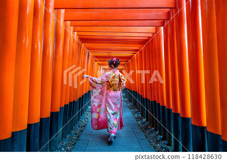 Asian women in traditional japanese kimonos at Fushimi Inari Shrine in Kyoto, Japan. Asian women in traditional japanese kimonos at Fushimi Inari Shrine in Kyoto, Japan. 118428630