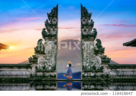 Young woman standing in temple gates at Lempuyang Luhur temple in Bali, Indonesia. Young woman standing in temple gates at Lempuyang Luhur temple in Bali, Indonesia. 118428647