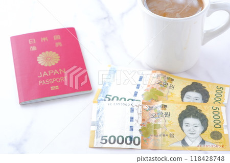 Image of Korean won (KRW) banknotes (50,000 won note) and a coffee cup planning a trip to Korea Image of Korean won (KRW) banknotes (50,000 won note) and a coffee cup planning a trip to Korea 118428748