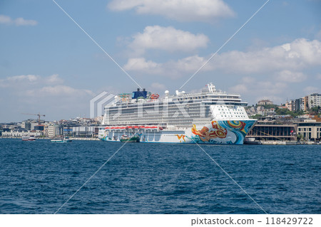 A massive cruise ship parked off Istanbul's shore, capturing the blend of maritime beauty and urban landscape. Great for tourism and seafaring themes A massive cruise ship parked off Istanbul's shore, capturing the blend of maritime beauty and urban landscape. Great for tourism and seafaring themes 118429722