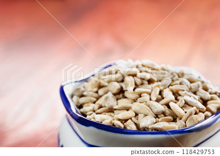 Bunch of sunflower seeds in bowl Bunch of sunflower seeds in bowl 118429753