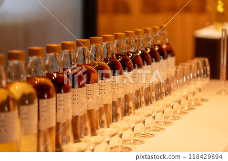 Bottles lined up at a whiskey distillery 118429894