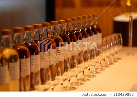 Bottles lined up at a whiskey distillery 118429896