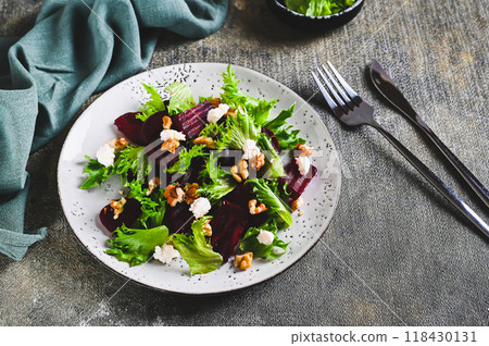 Beetroot salad with cheese, nuts and herbs on a plate on the table Beetroot salad with cheese, nuts and herbs on a plate on the table 118430131