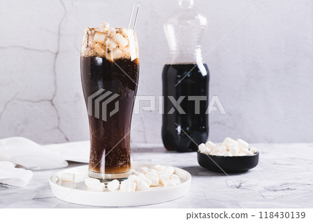 Trendy drink of cola and marshmallow in a glass on the table Trendy drink of cola and marshmallow in a glass on the table 118430139