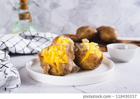 Young potatoes boiled in their skins on a plate on the table Young potatoes boiled in their skins on a plate on the table 118430157