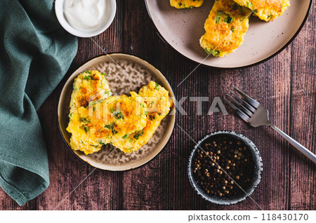 Delicious fried potato and broccoli sticks on a plate on the table top view Delicious fried potato and broccoli sticks on a plate on the table top view 118430170