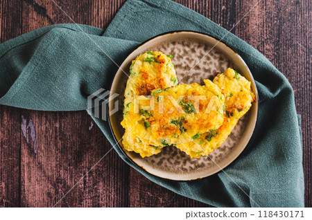 Close up of delicious fried potato and broccoli sticks on a plate on the table top view 118430171