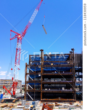 A building construction site with a large crane in operation 118430959