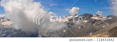 Panoramic Mountain View with Snow-Capped Peaks and Clouds 118431642