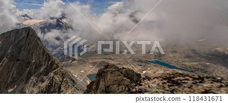 Panoramic Alpine View with Clouds and Snow-Capped Peaks Panoramic Alpine View with Clouds and Snow-Capped Peaks 118431671