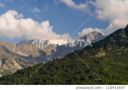 Snow-Capped Mountain Peaks Amidst Clouds 118431697