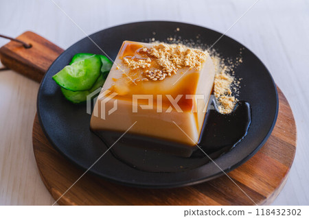 White sesame tofu with kinako and brown sugar syrup White sesame tofu with kinako and brown sugar syrup 118432302