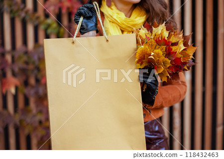 Closeup on young 40 years old woman in orange trench coat Closeup on young 40 years old woman in orange trench coat 118432463