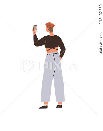 A young individual with short hair is seen taking a selfie with a smartphone, dressed in a crop top and wide-leg pants. Ideal for youth culture, social media, fashion, modern tech, casual style 118432726