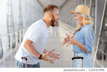 Young tourists arguing because of forgotten things, arriving at airport, side view Young tourists arguing because of forgotten things, arriving at airport, side view 118432990