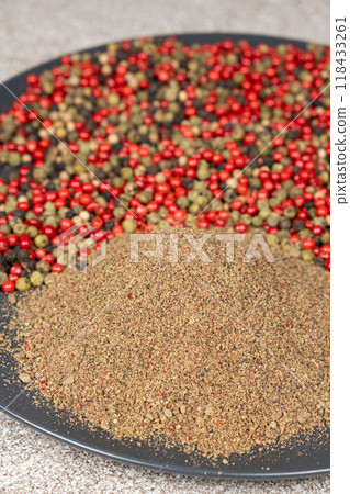 Ground pepper, a mixture of red, green, white and black pepper. 118433261