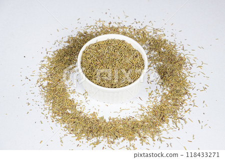 Seasoning dried rosemary in a plate on white background 118433271