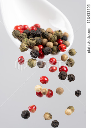 Different types of peppercorns pouring. Red, green, white and black pepper. Different types of peppercorns pouring. Red, green, white and black pepper. 118433303