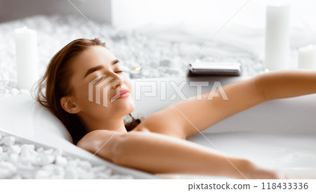 Woman Enjoying Milky Bath After Work Day, Lying With Closed Eyes 118433336