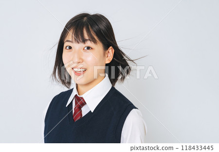 A female student in uniform with her hair blowing in the wind A female student in uniform with her hair blowing in the wind 118433445