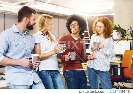 Successful young business people sharing ideas and smiling during coffee break Successful young business people sharing ideas and smiling during coffee break 118433446