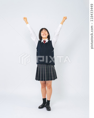 Full-body photo of female student raising her arms in the air Full-body photo of female student raising her arms in the air 118433449