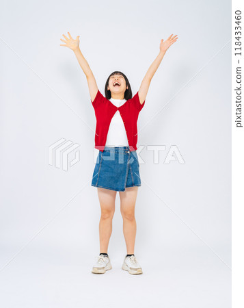 Full body photo of a girl raising her arms in the air 118433460